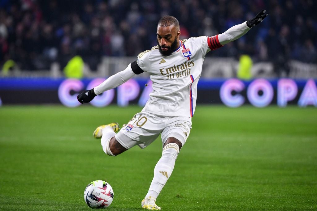 Olympique Lyonnais striker Alexandre Lacazette winds up to take a shot while wearing a match shirt featuring the Emirates Logo