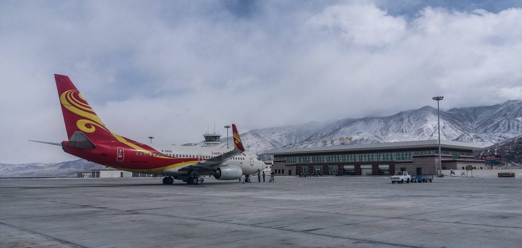 A Lucky Air aircraft stands at the terminal of Ali Kunsha Airport