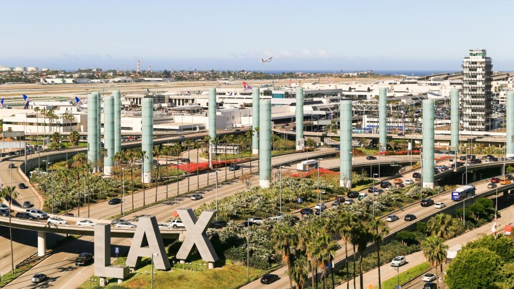 Los Angeles International Airport (LAX) seen from across the highway with an LAX sign in front